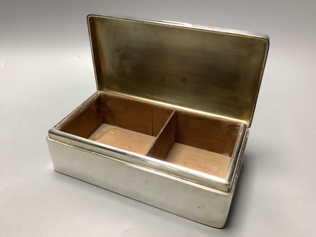 A 1930s silver rectangular cigarette box with engraved inscription.
